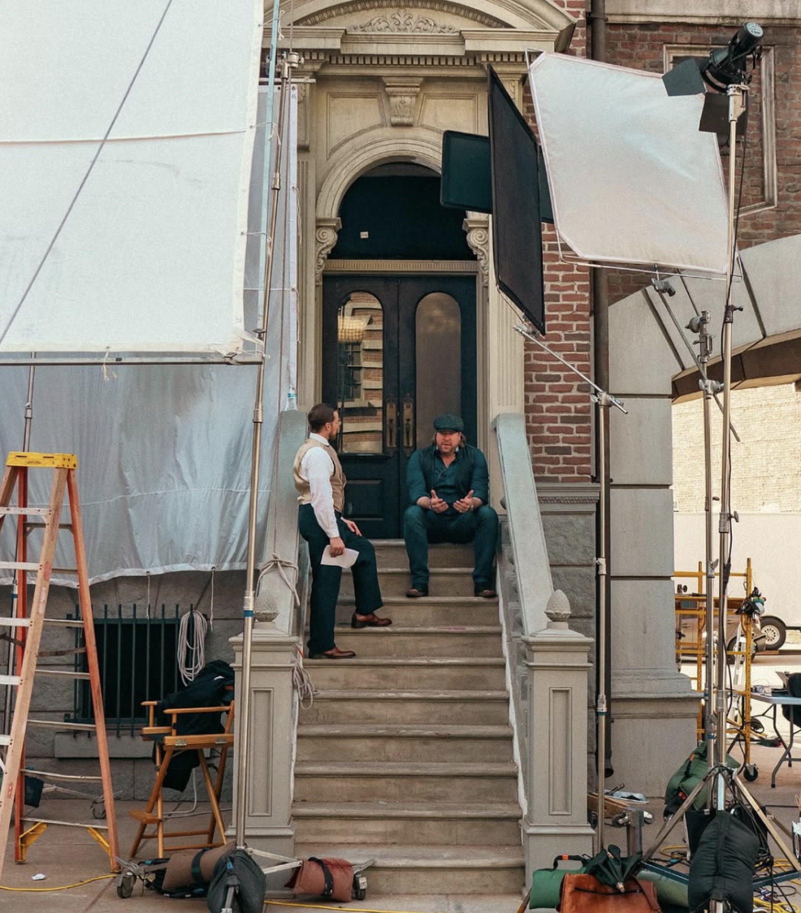 Tanner Beard talking through a scene with crew on location steps